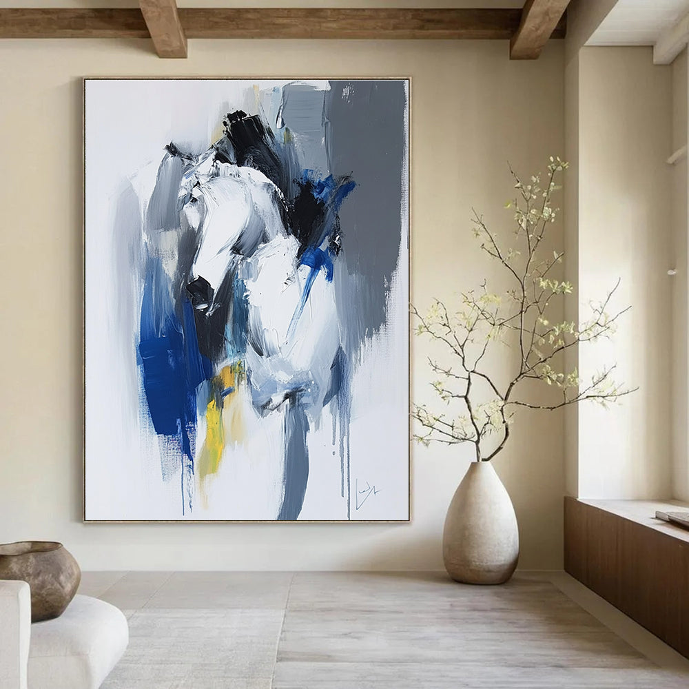 Large abstract painting in blue and white with dynamic brushstrokes reveals movement and emotion featuring elements of strength and energy.STSC036