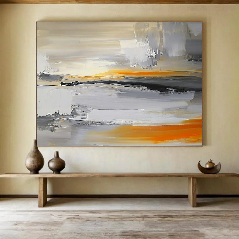 Large abstract painting featuring a grey, white, and orange sky with a blurred horizon and rocks below in a minimalist style.SC175