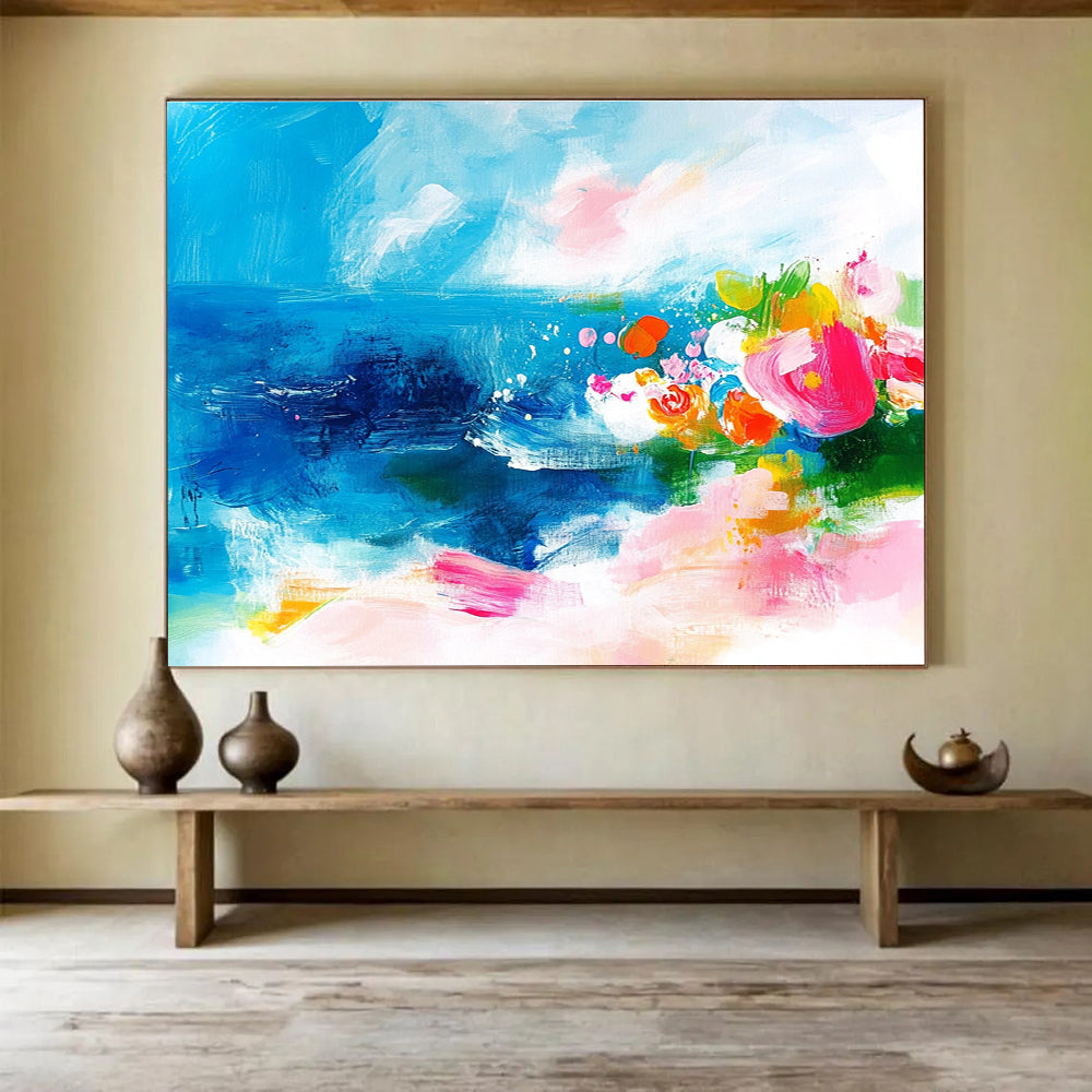 Large abstract painting of the ocean featuring bold brush strokes in pink blue green and orange with small flowers on a textured white background.SC363