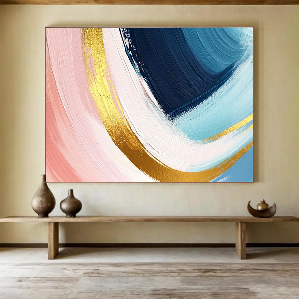 A large abstract painting in pastel pink blue and yellow with dynamic brushstrokes and gold outlines evoking joy and warmth.SC443
