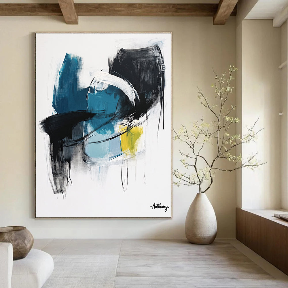 Large abstract painting in blue black and white tones with yellow accent by Anthony evoking calmness and serenity through soft brush strokes and thick lines.STSC1068