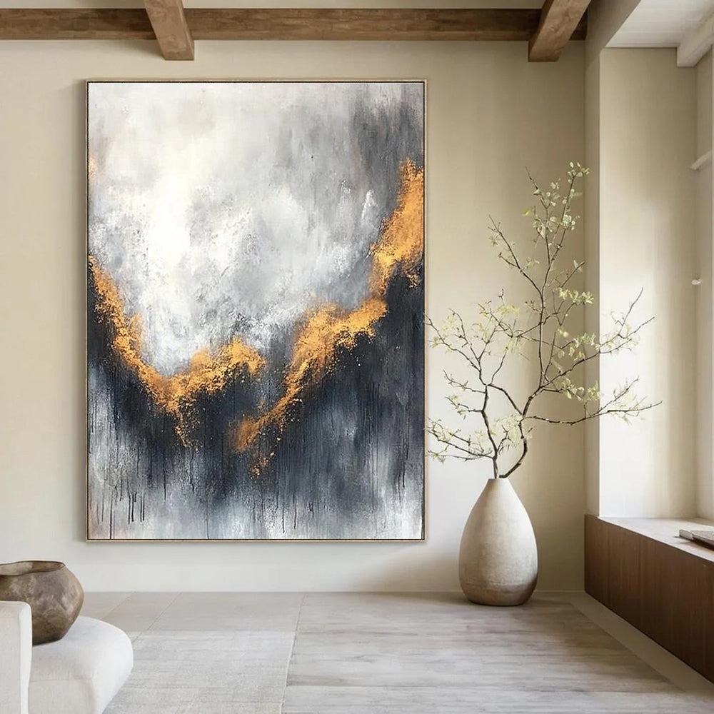 Large abstract painting with gray and white background golden accents atmospheric clouds and soft edges evokes calmness and introspection.STSC397