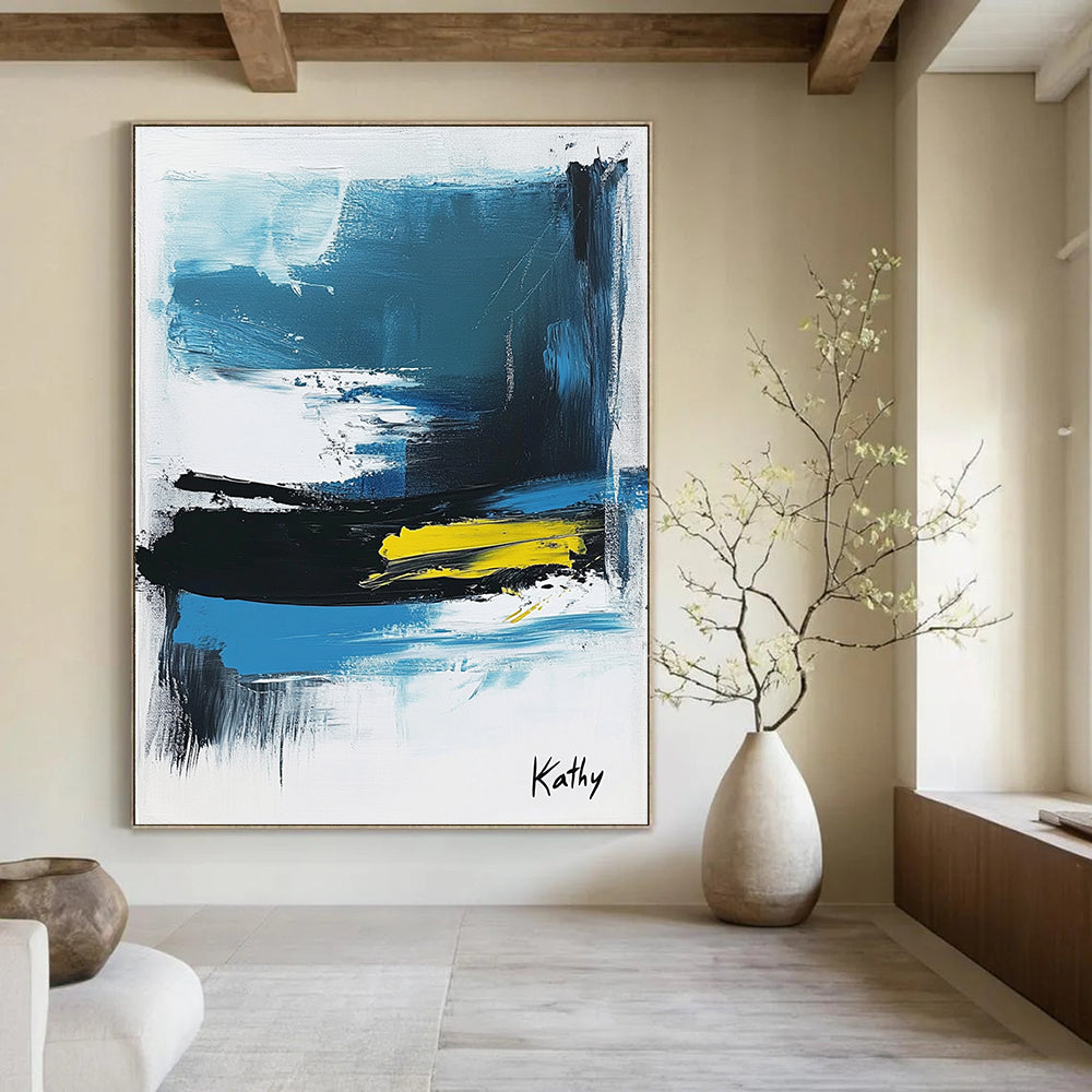 Large abstract painting of the sea featuring blue black and white brush strokes with yellow accents signed by Kathy.STSC1423