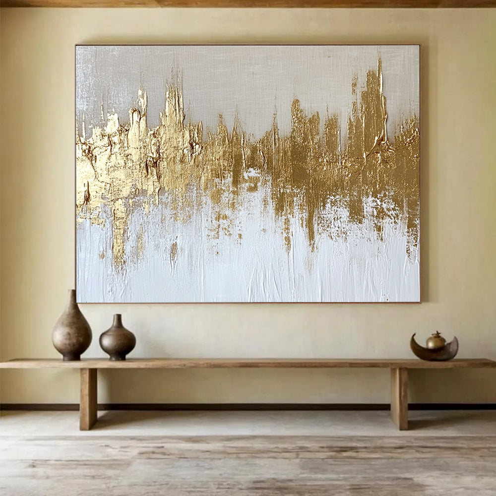 Large abstract painting of a gold and white cityscape with textured canvas and gold foil accents on a neutral background.SC173