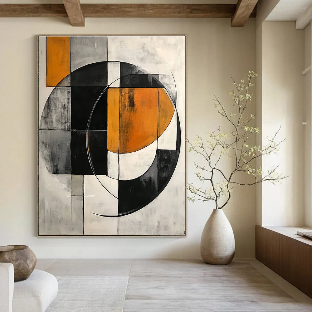 Large abstract painting featuring simple geometric shapes, circles, and half-circles in shades of gray, orange, black, and white.STSC221