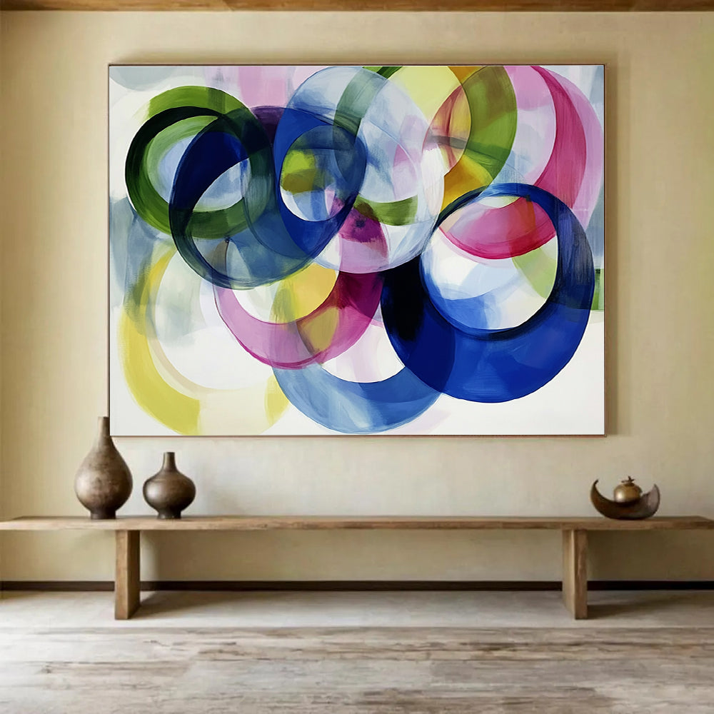 Large abstract painting with colorful overlapping circles on a white background showcasing joyful energy and playful modernity through soft edges and visible brushstrokes.SC525