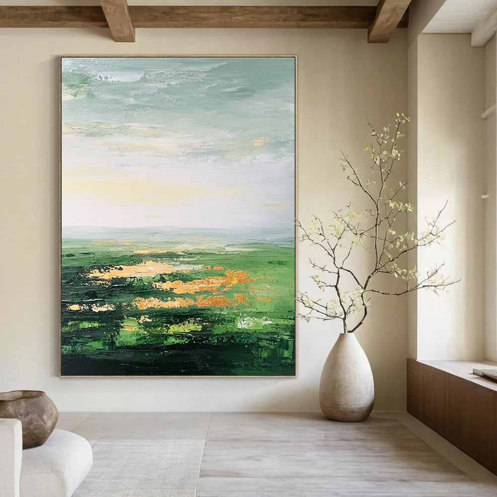 Large abstract painting featuring a vast green landscape soft sky gold accents and thick brush strokes for a dreamy blurry effect.STSC887