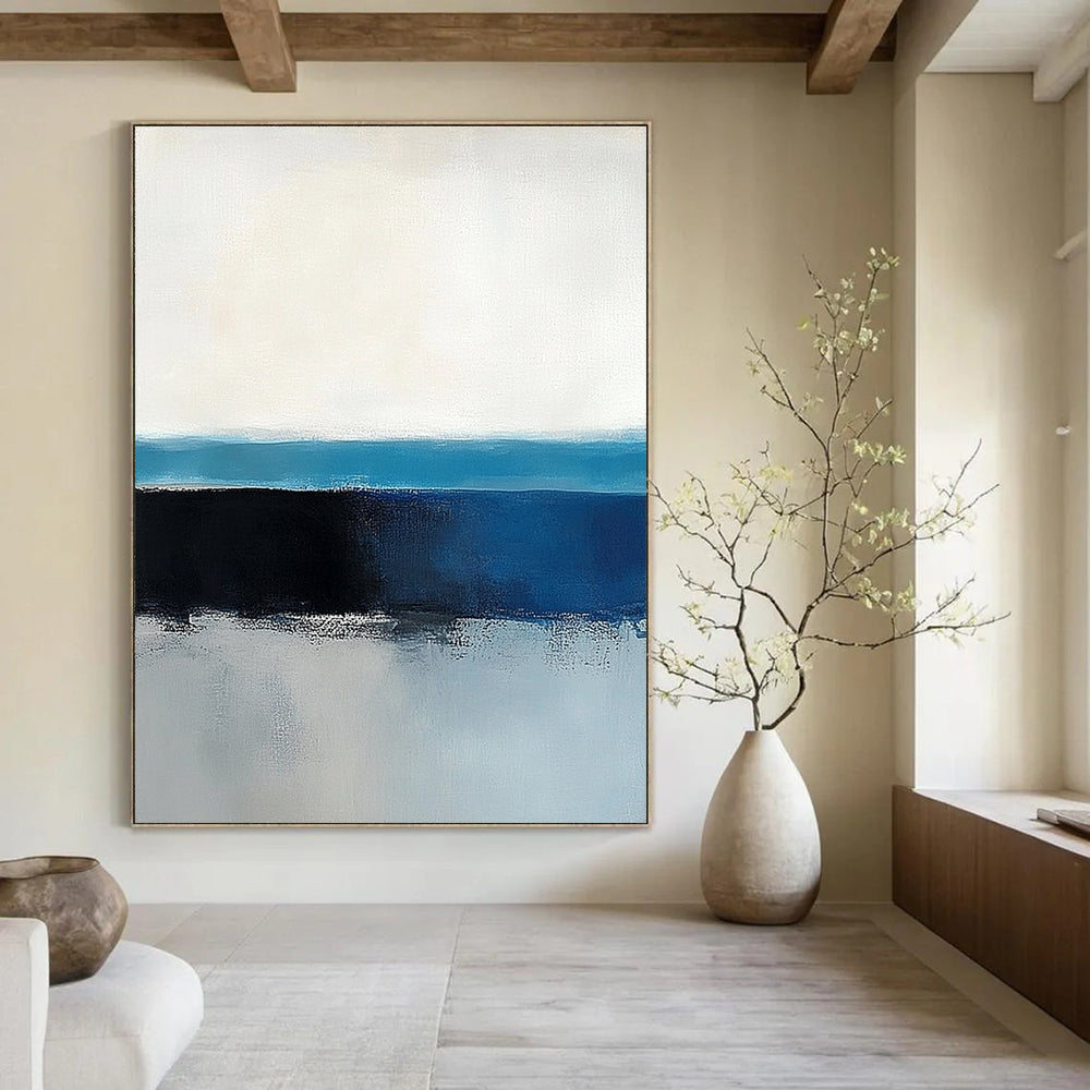 Large abstract painting of the ocean horizon featuring blue and gray tones in a minimalist style with neutral colors.STSC342