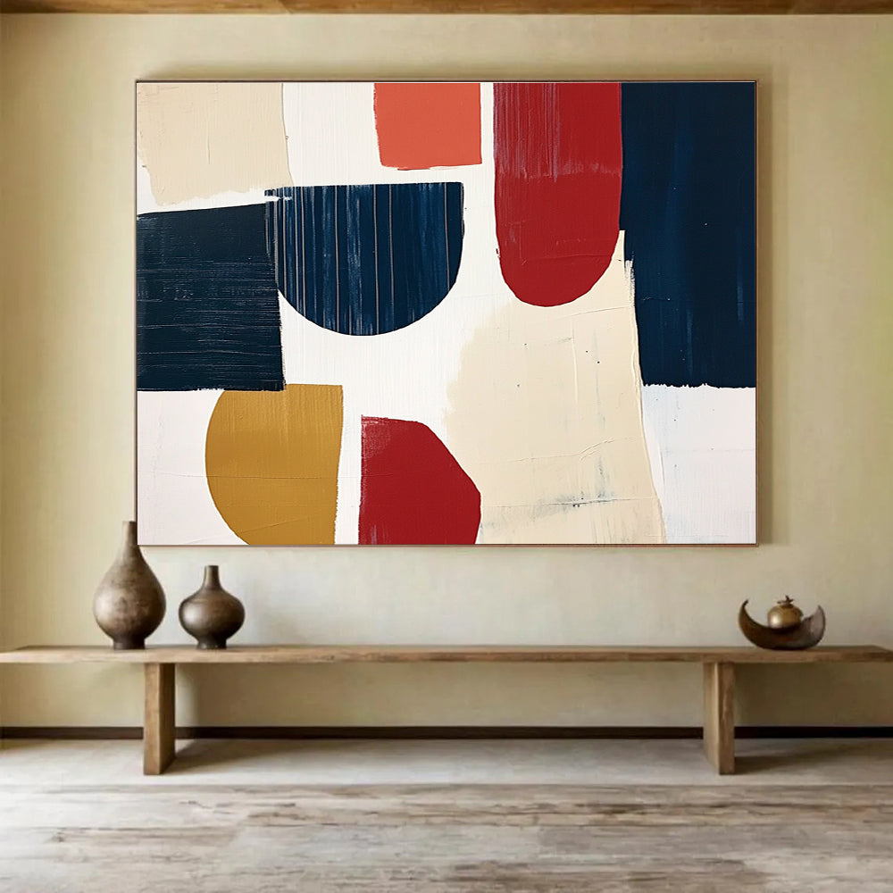 A large abstract painting featuring navy blue cream and red shapes with loose brush strokes on a white background in a collage style.SC489
