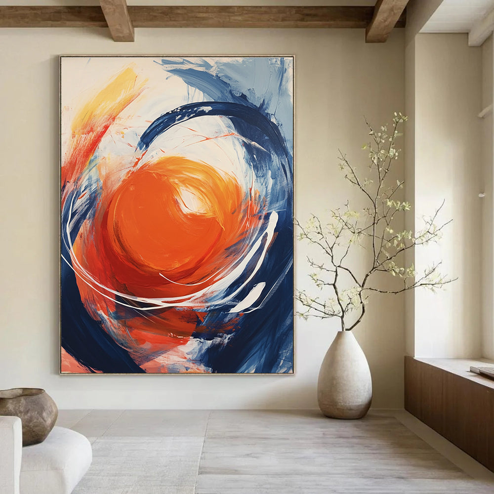 Large abstract painting featuring an orange orb with swirling white energy against a light gray background showcasing vibrant colors and dynamic brushstrokes.STSC744