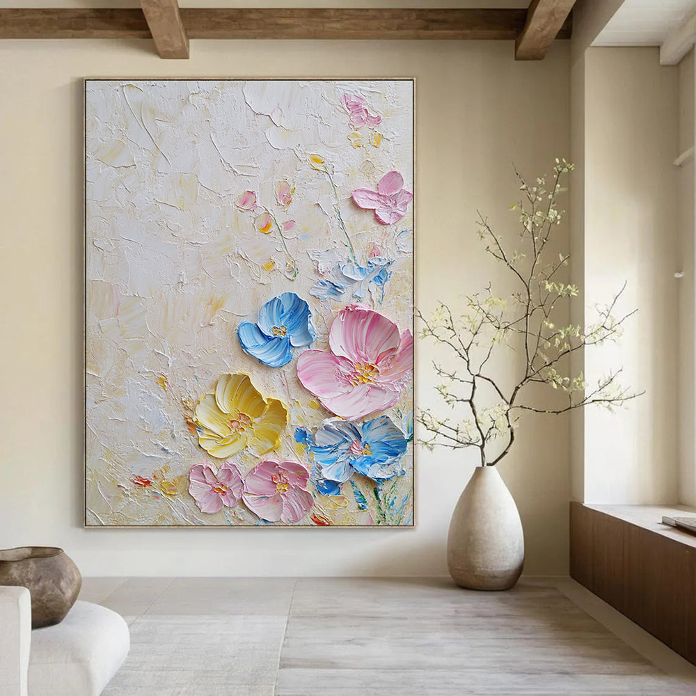 Large abstract painting with textured layers featuring pastel flowers in pink and blue on a white background illuminated by soft lighting.STSC1366