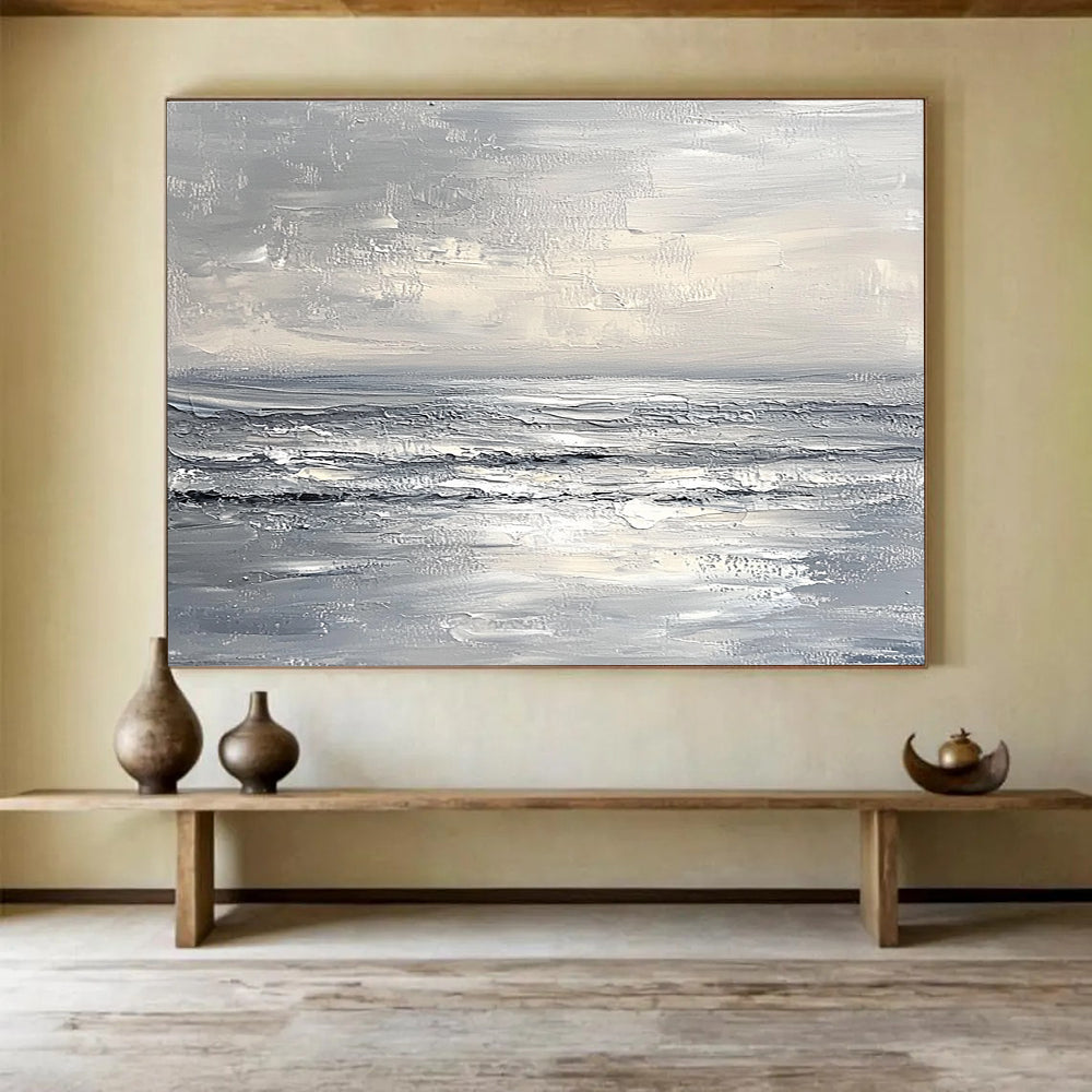 Abstract seascape in impasto oil, featuring textured strokes in muted whites and greys, capturing a minimalist beach with soft waves and sky.SC276