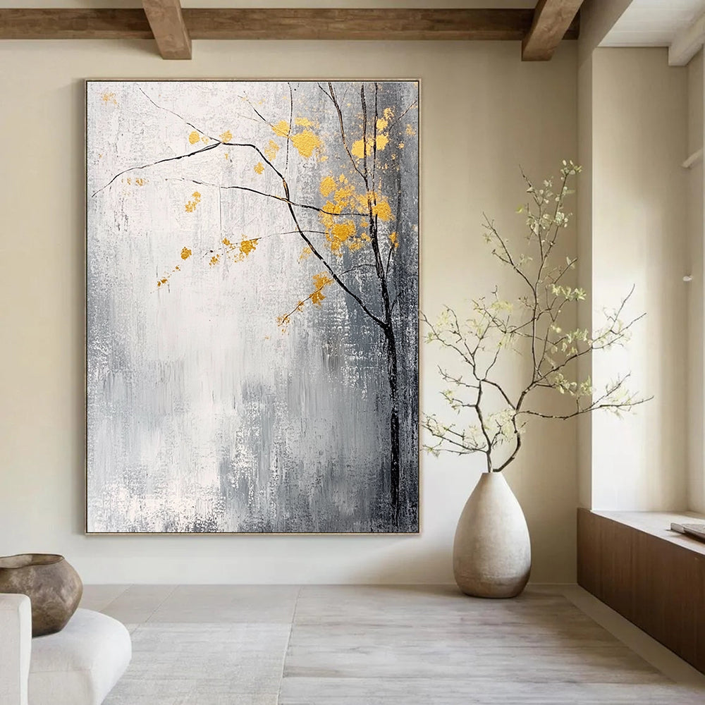 Large abstract painting with gray and white background yellow accents and delicate gold leaves creating a tranquil and mysterious atmosphere.STSC395