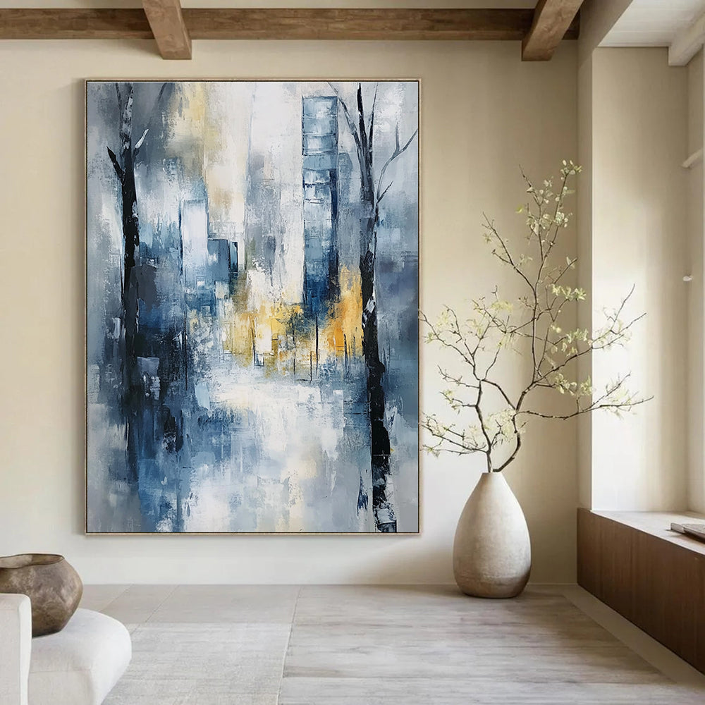 Large abstract painting of an urban cityscape in soft blue and grey tones with hints of yellow and white, featuring expressionist elements and a serene mood.STSC278