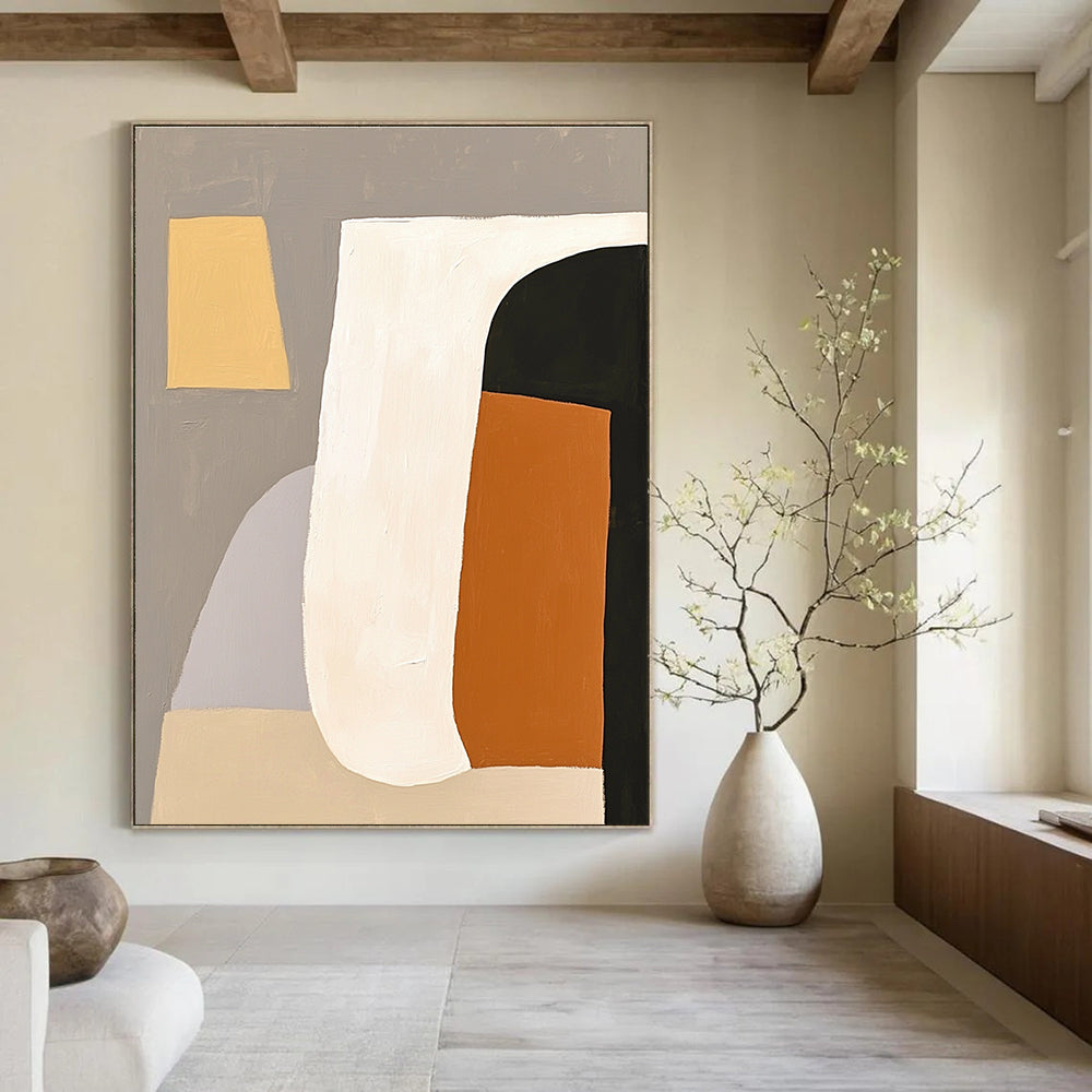 Large abstract painting featuring white shapes with an orange and black form against a grey background embodying minimalism and elegance.STSC628