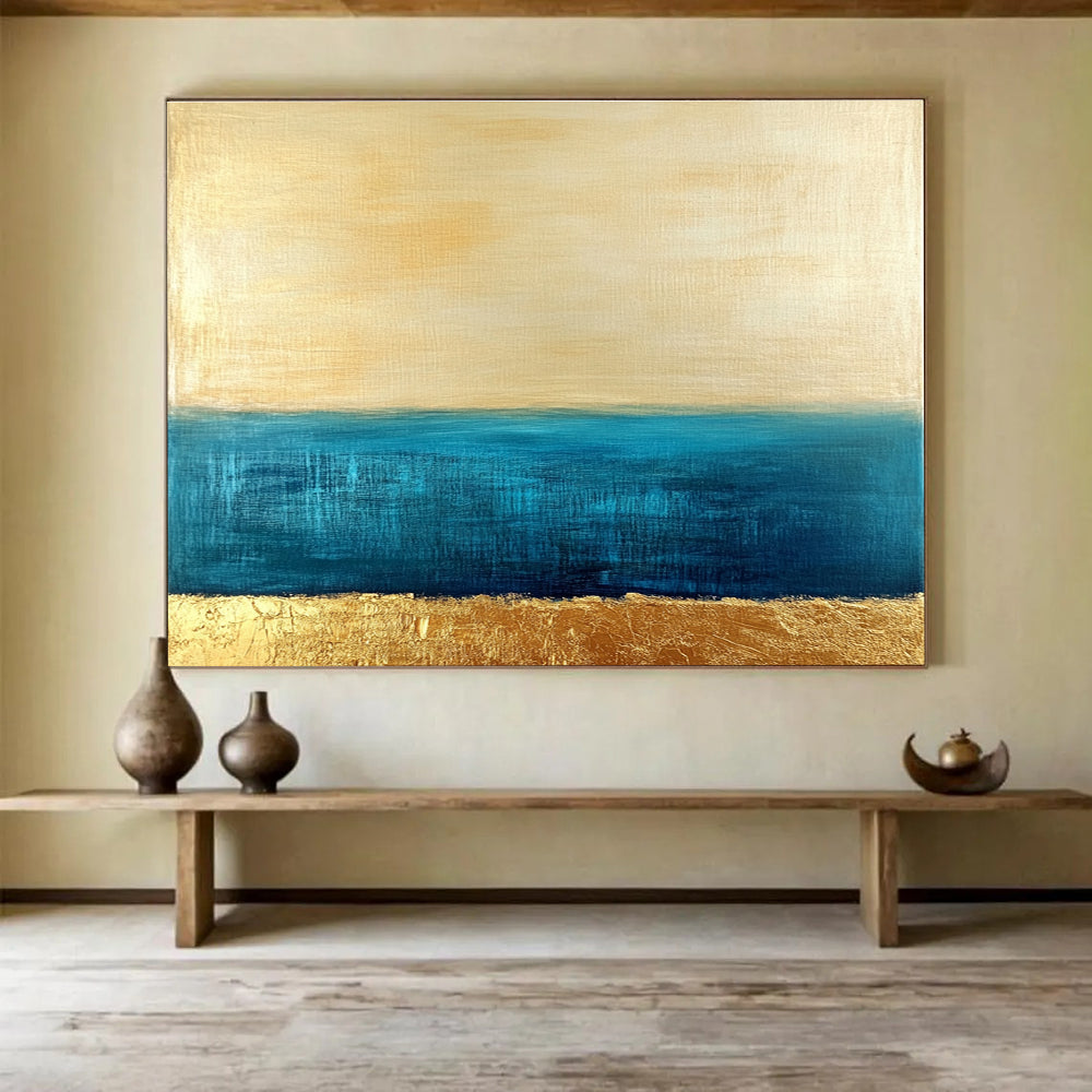 Large abstract painting featuring a golden sky and blue sea with textured gold accents and a soft minimalist aesthetic.SC172