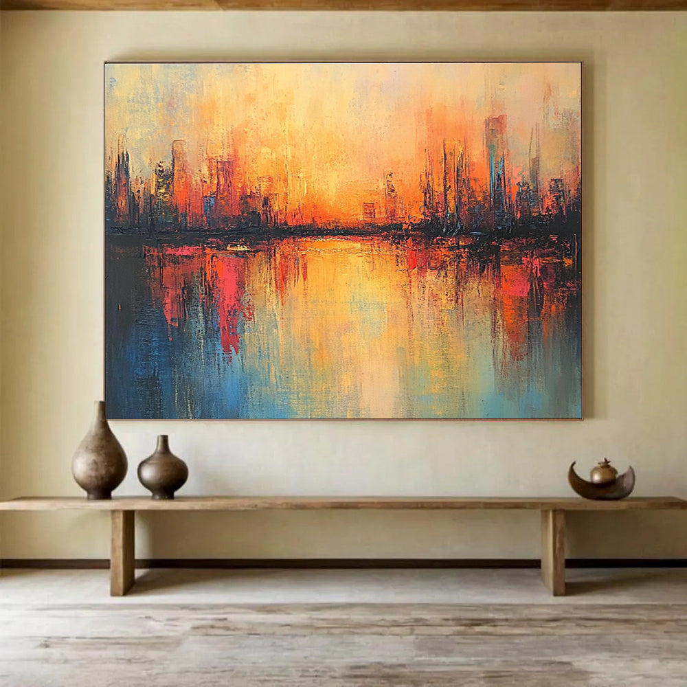 Large abstract painting featuring a cityscape in warm hues with soft brush strokes and reflections on calm waters, evoking a serene sunrise atmosphere.SC037