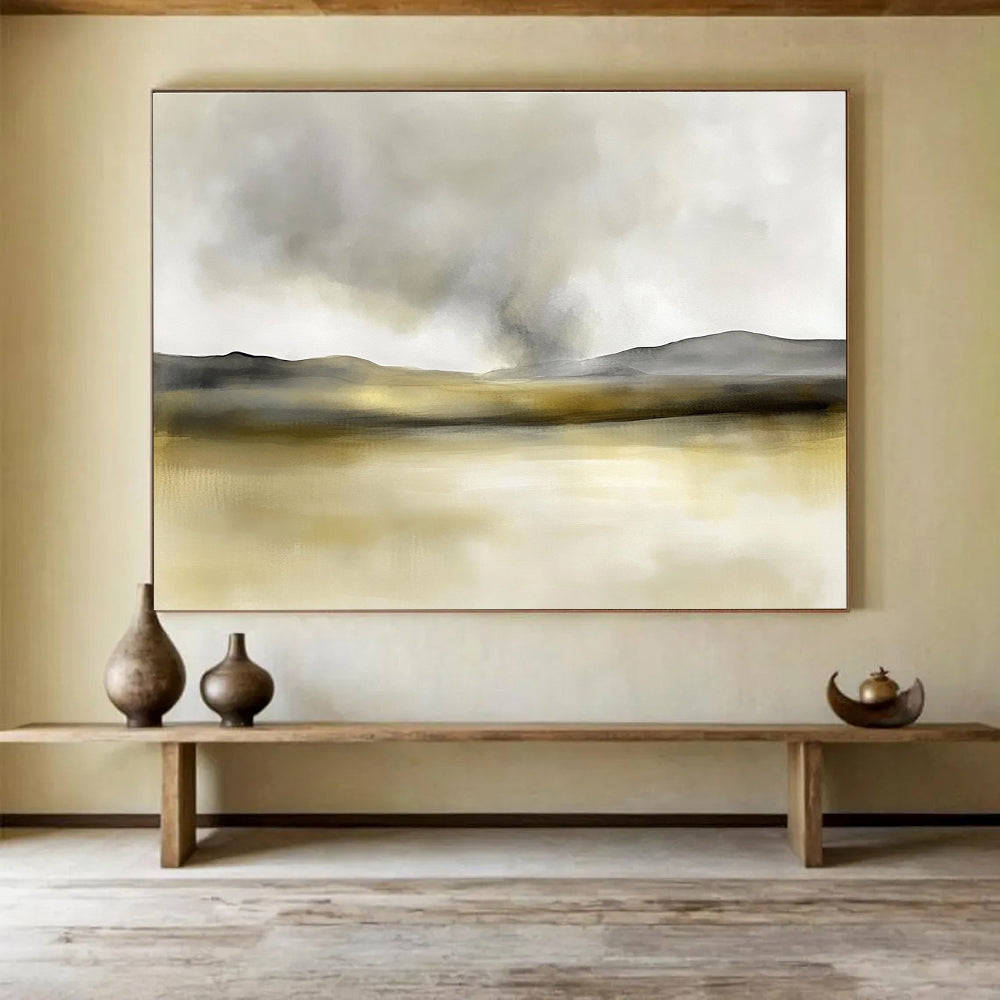 Large abstract painting in soft watercolors featuring neutral beige and gray tones with yellow accents and distant rolling hills under smoke.SC075