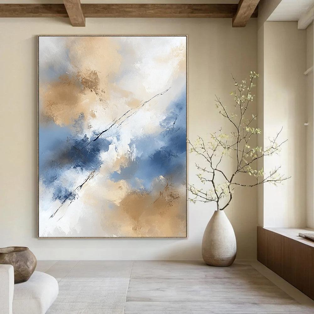 Large abstract painting in beige and blue tones features white clouds creating an ethereal ambiance with delicate brushstrokes and flowing lines.STSC409
