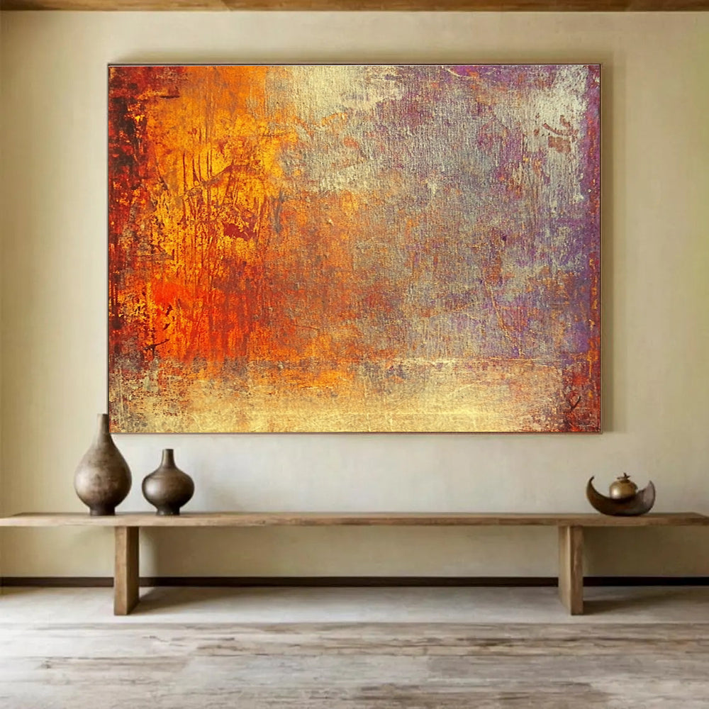 A large abstract painting featuring warm tones of gold reds and oranges evokes autumn's energy and symbolizes life's transitions with a golden sunset backdrop.SC432