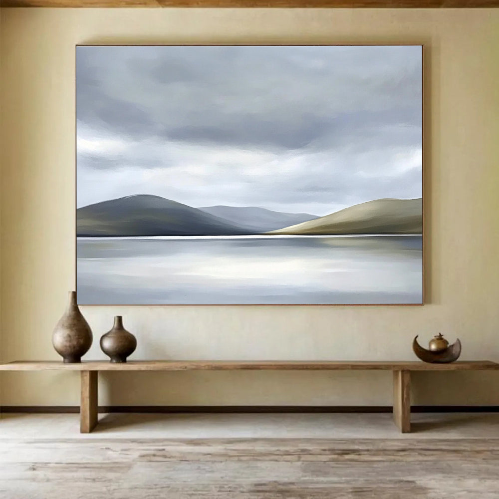 Large abstract painting of the Scottish Highlands featuring muted colors soft light grey sky white clouds and a serene lake in the foreground.SC131