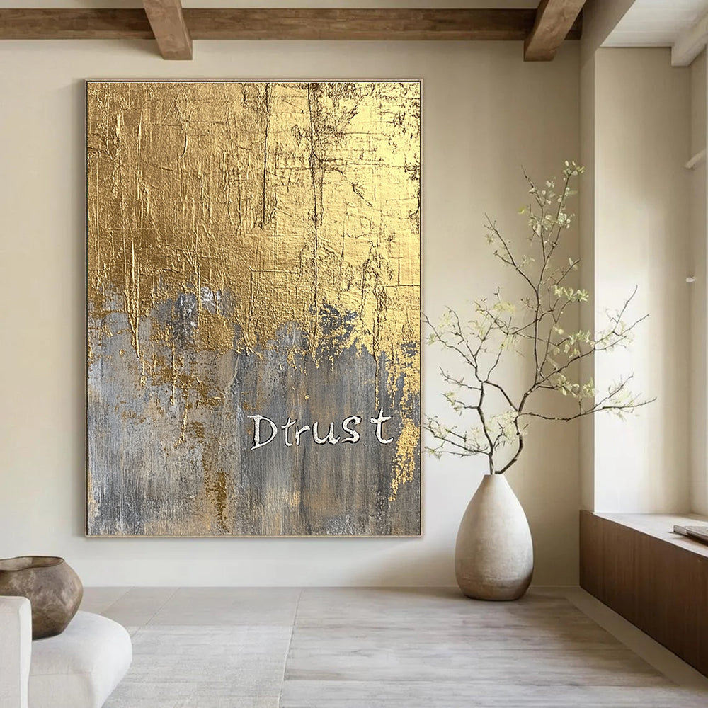 A large abstract painting featuring a gold foil background and textured silver lettering of Dtrust with elegant luxury and depth.STSC1003