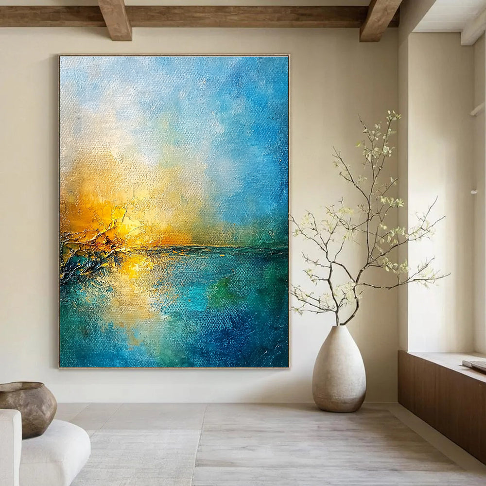 Large abstract painting of a golden sunset over a blue sea featuring textured canvas and rustic-core style nature-inspired colors.STSC165