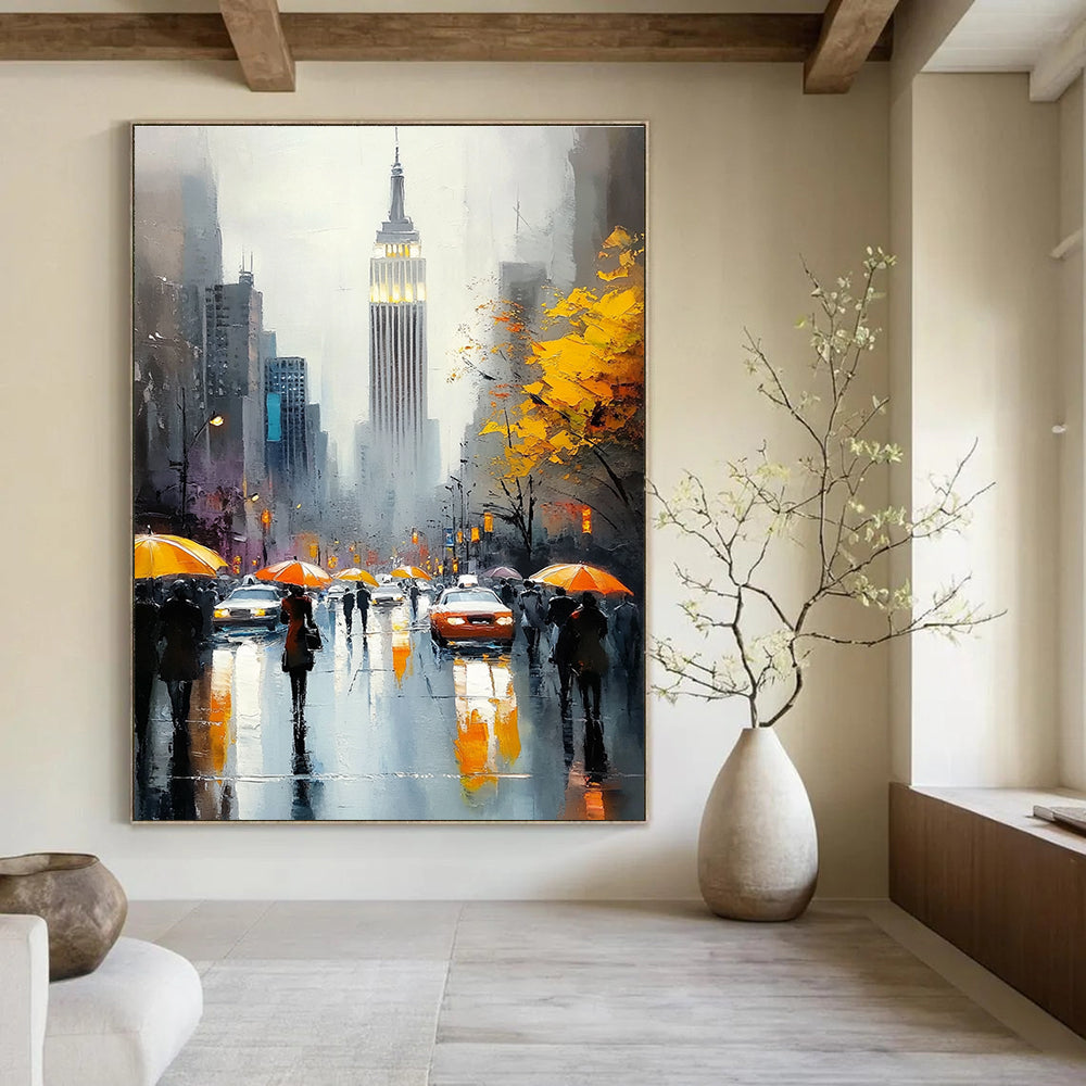 A large abstract painting capturing the Empire State Building with vibrant crowds on a rainy day featuring reflections and warm accents.STSC1137