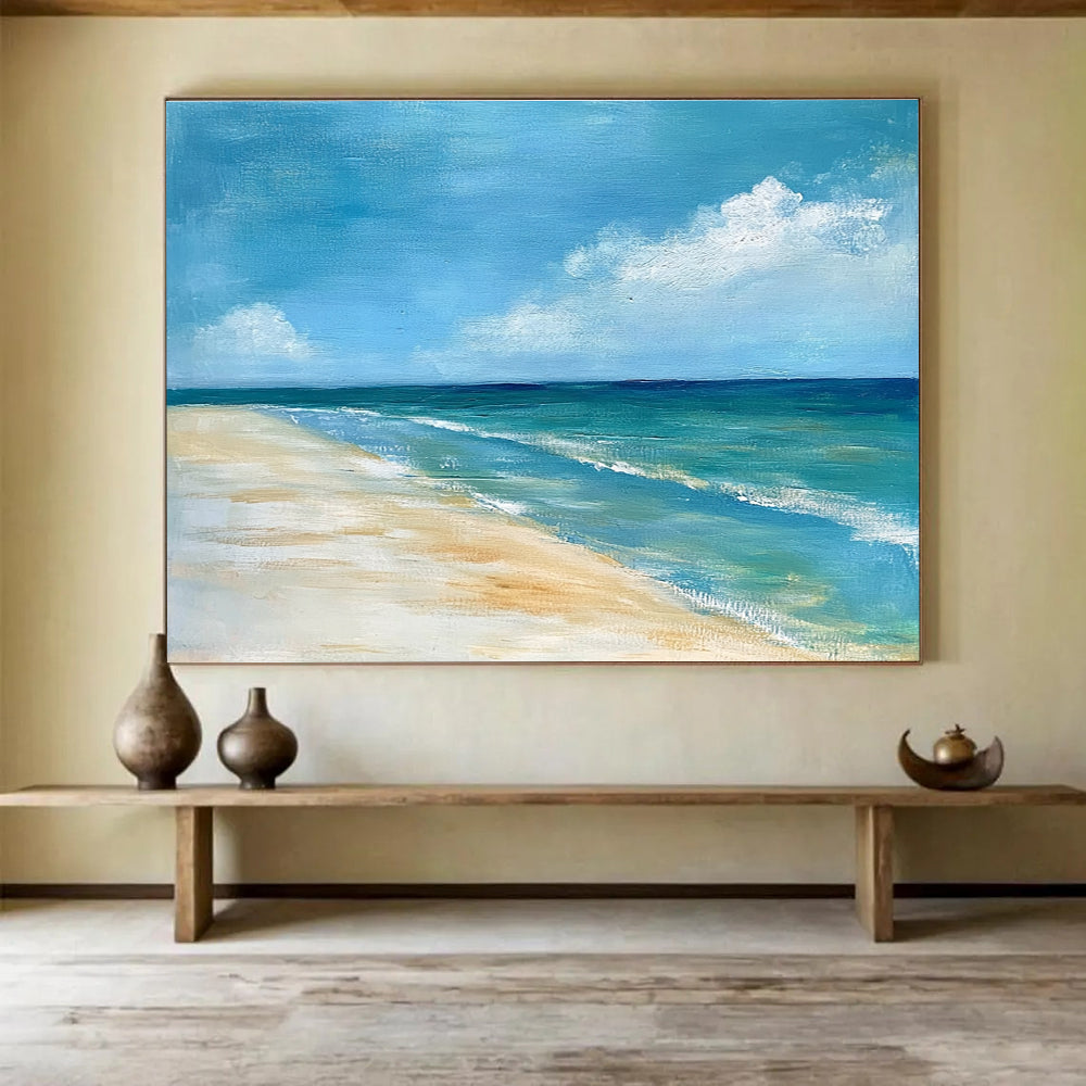 A large abstract painting of the ocean sky and sandy beach in muted blue tones with green accents and soft clouds for a serene ambiance.SC362