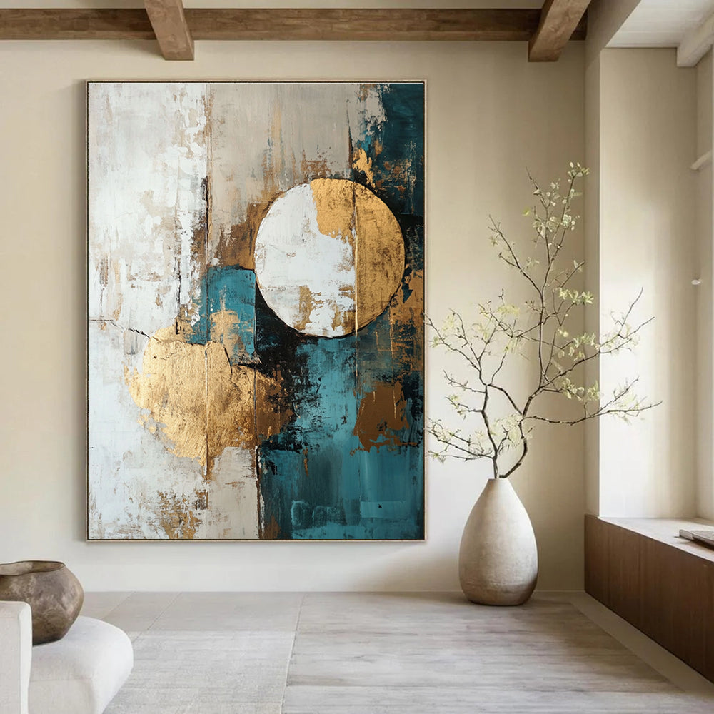Large abstract painting featuring shapes and lines in white beige teal blue and brown with gold foil accents.STSC193