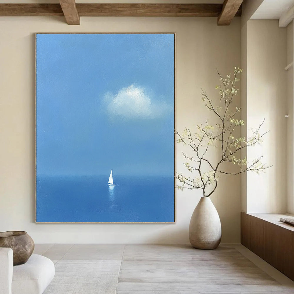 Large abstract painting featuring a white sailboat on the sea in light blue and indigo colors creating a dreamy atmosphere with ethereal clouds.STSC1255