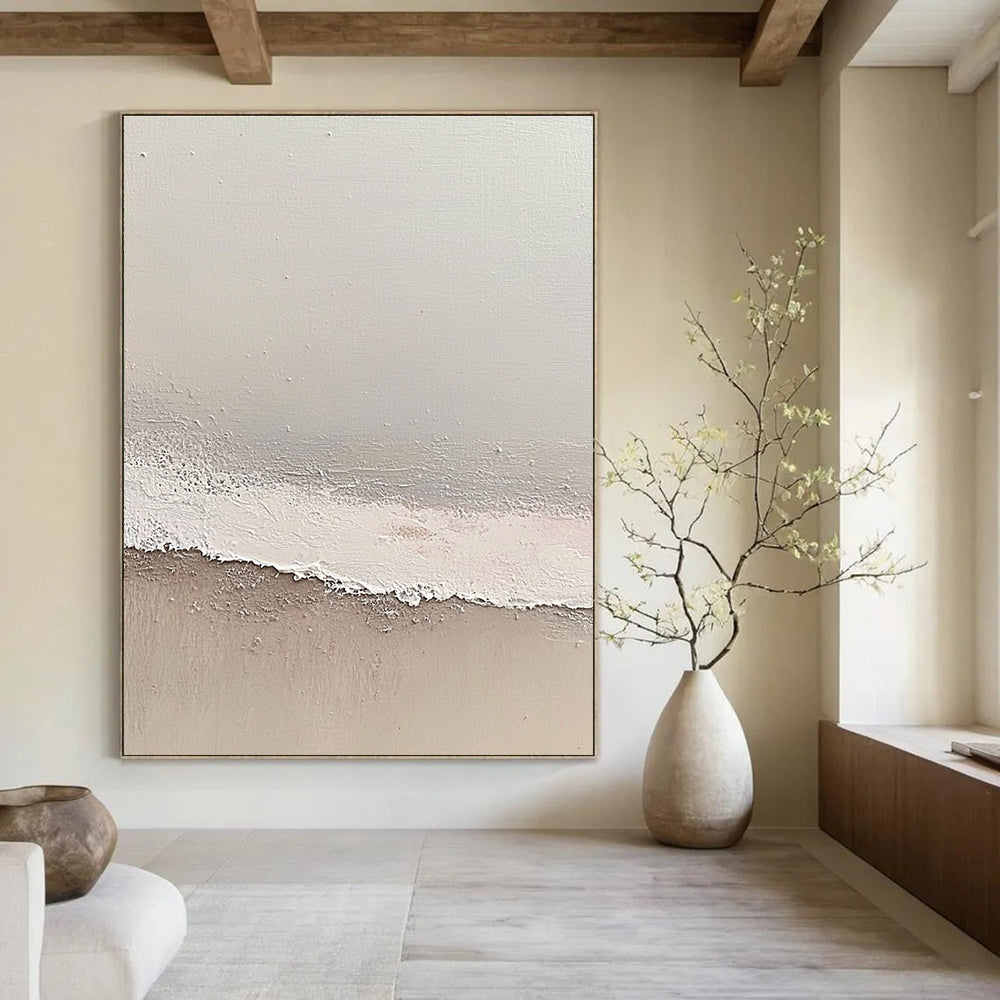 Large abstract painting depicting a serene beach scene with soft gray and pale pink tones featuring gentle waves and textured surfaces.STSC1427