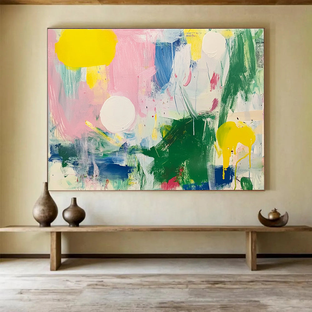 Large abstract painting featuring bright colors with green and pink shapes white circles yellow lines blue lines and light red elements on a white background.SC231