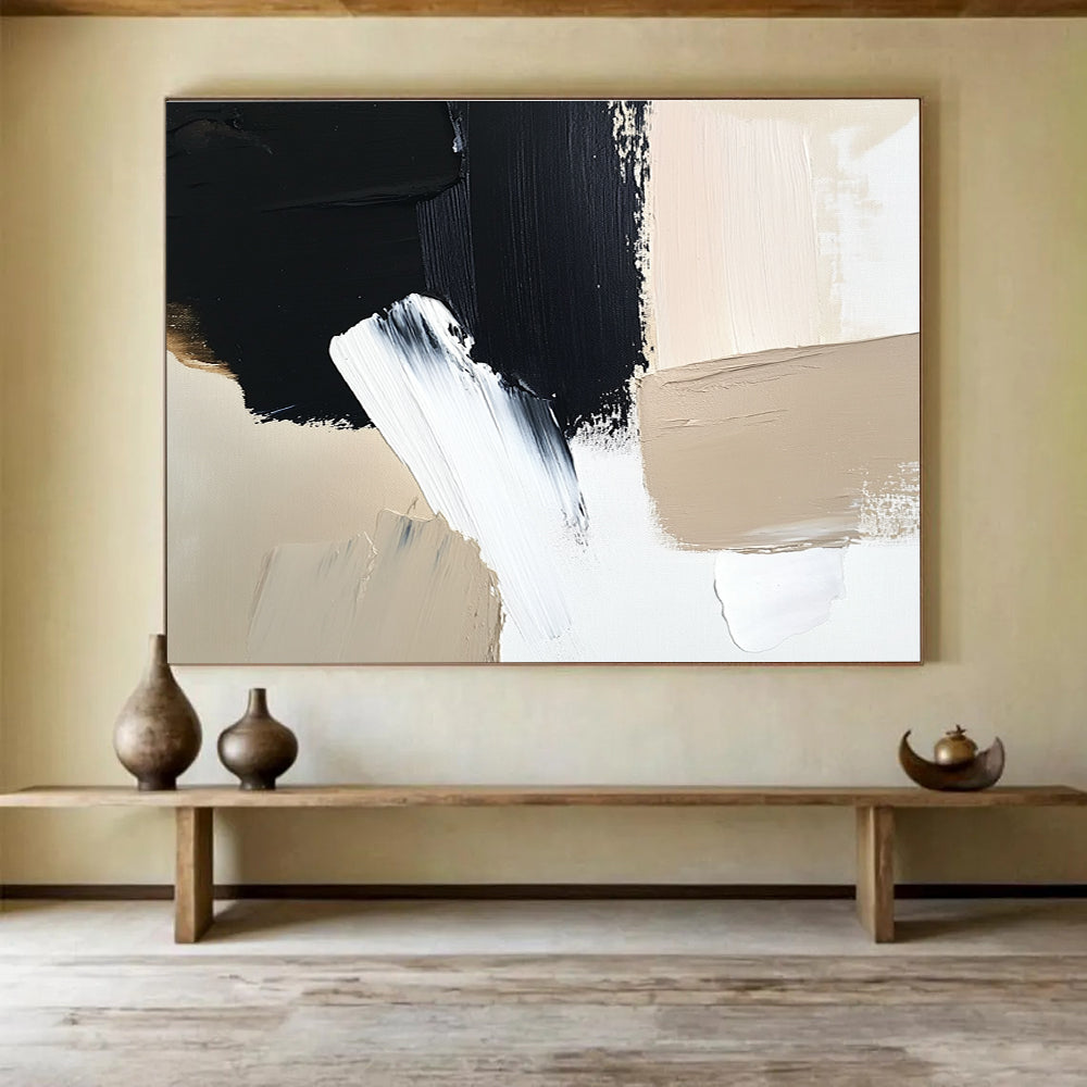 Large abstract painting featuring black brush strokes on a white background complemented by a minimalist beige and cream color palette.SC012