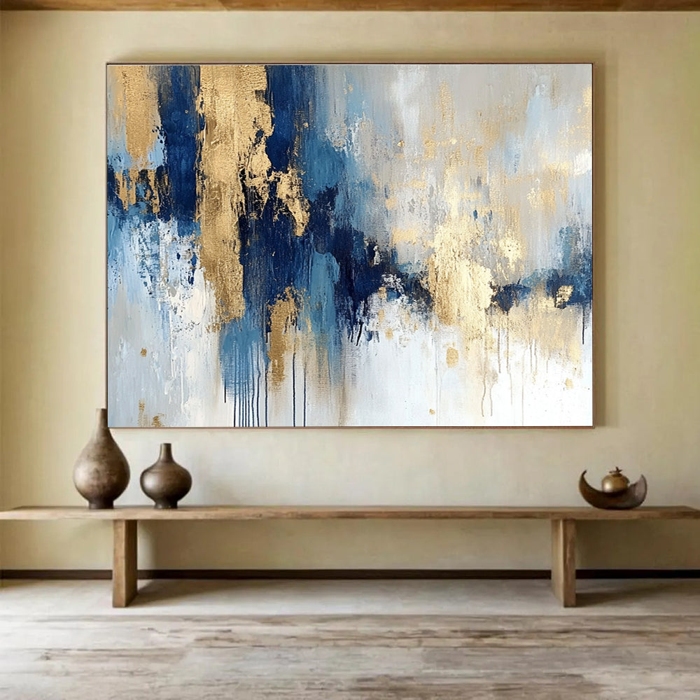 Large abstract painting in blue and gold with soft edges and texture featuring modern elegance and movement on a white background.SC021