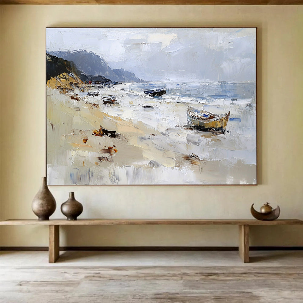 Large abstract oil painting of a beach with loose brush strokes featuring white gray and brown colors and visible sea spray and mountains in the background.SC605