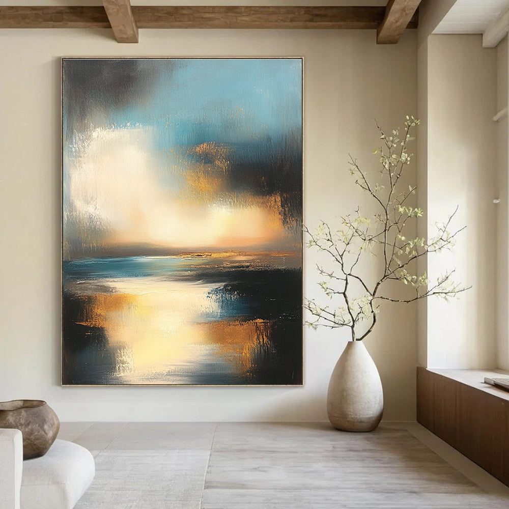 Large abstract oil painting depicting the ocean and sky at sunset with muted colors and gold accents for a serene ambiance.STSC196