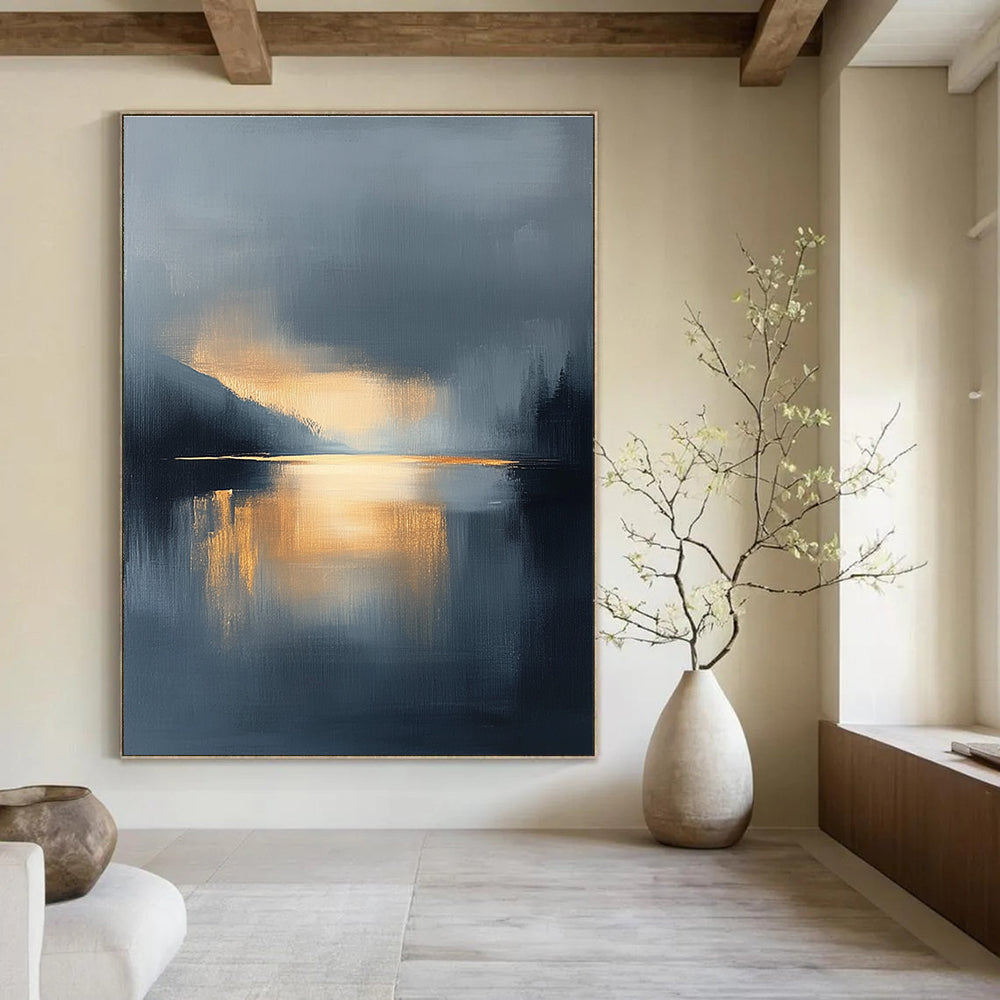 Large abstract oil painting featuring a lake and sky with navy blue and gold tones atmospheric clouds and reflections in calm waters.STSC167