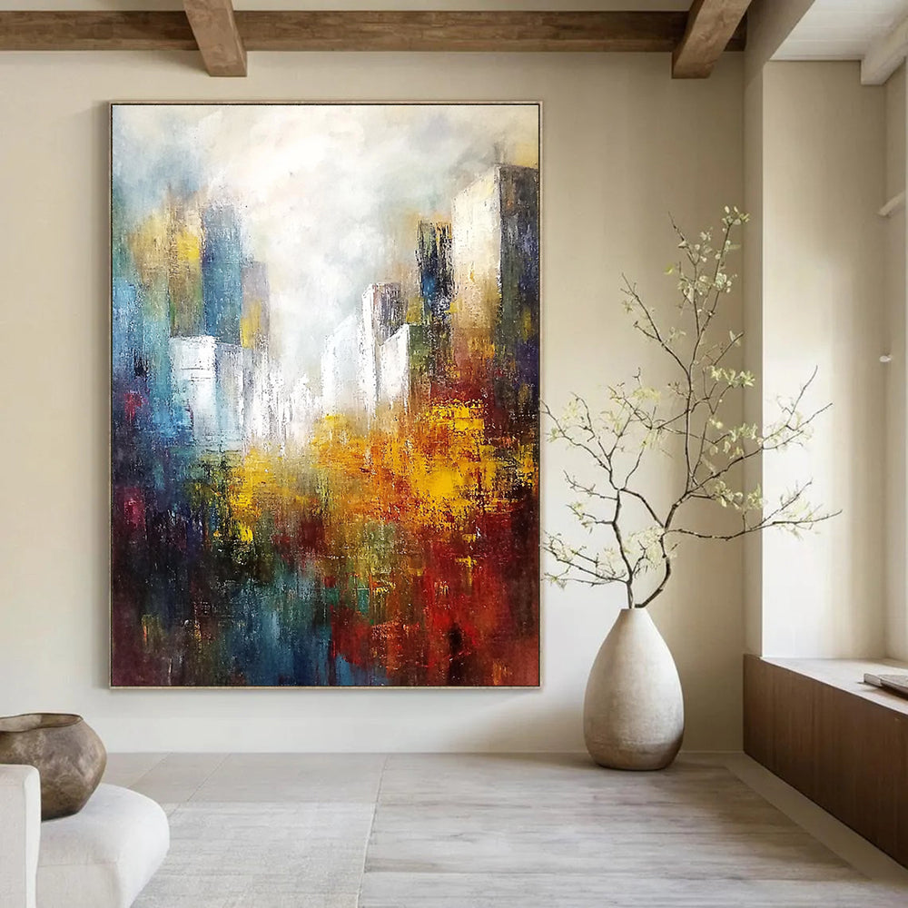 Large abstract landscape painting featuring white buildings in the distance with soft edges and muted tones in a light sky blue and dark amber palette.STSC106