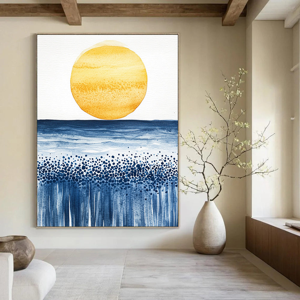 Abstract watercolor painting of a sun rising over the ocean with minimalist yellow and blue tones on textured paper.STSC505
