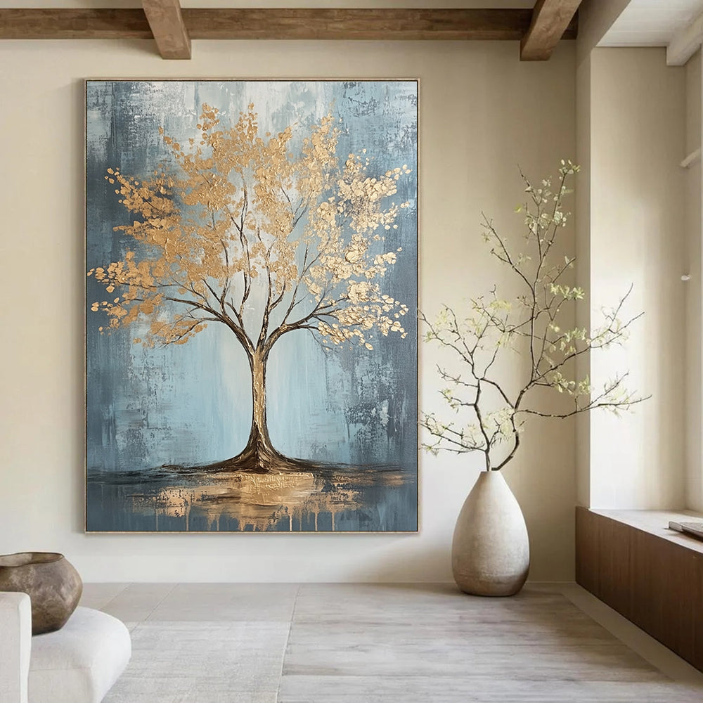 Large abstract painting with gold leaf accents on grey and light blue textured canvas featuring dynamic brush strokes and warm lighting, embodying sophisticated bohemian style.STSC493