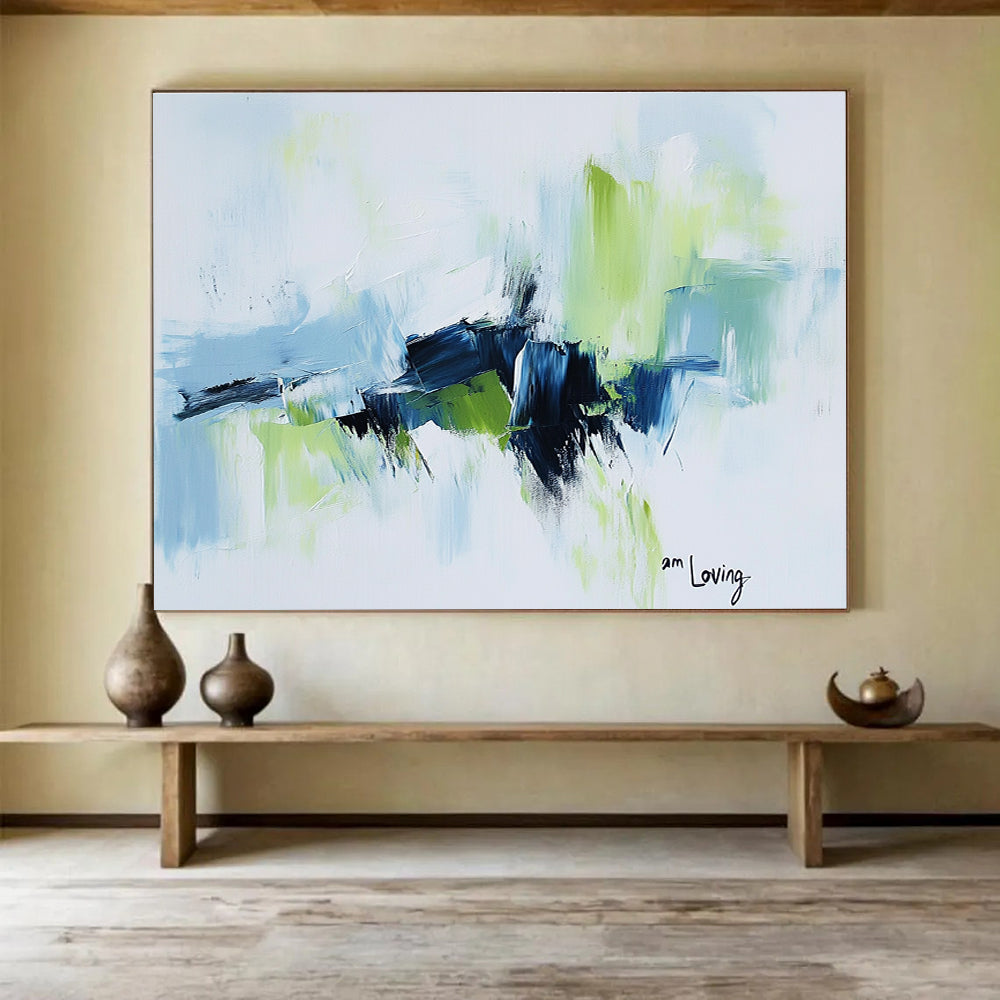 Abstract painting with a white background highlighted by light blue and green accents features expressive brush strokes and the words am loving.SC214