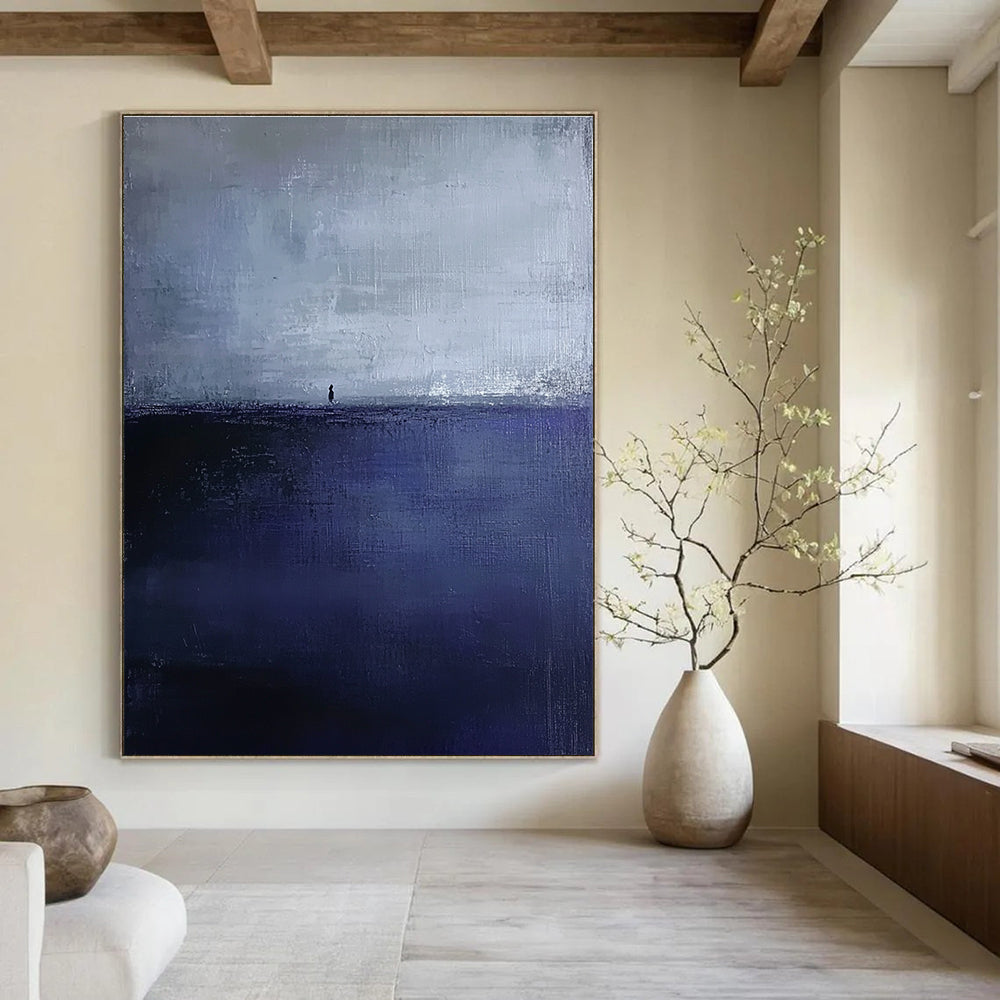 Large abstract painting in dark blue and gray depicting an atmospheric seascape with a small silhouette on the distant horizon.STSC1085