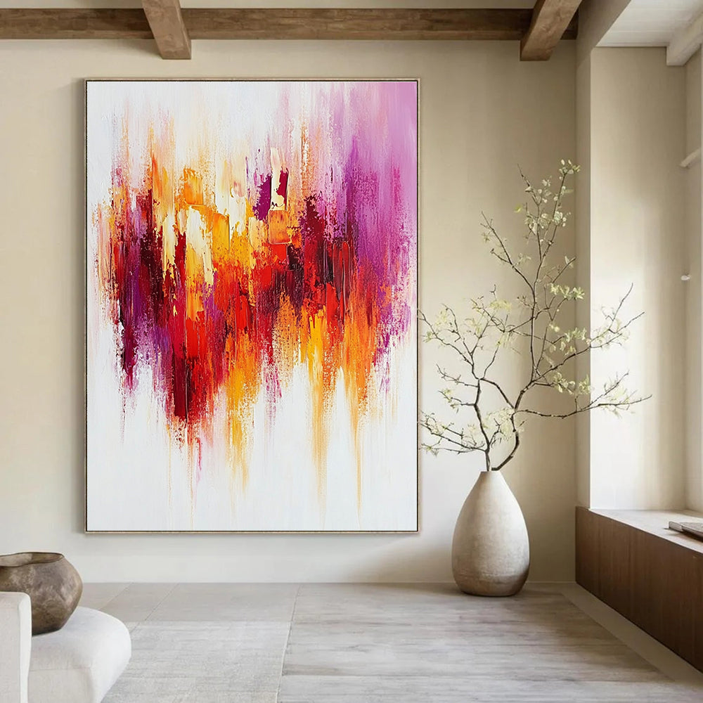 Large abstract painting with textured brush strokes in warm reds and yellows accented by purple on a white background creating a happy uplifting mood.STSC814