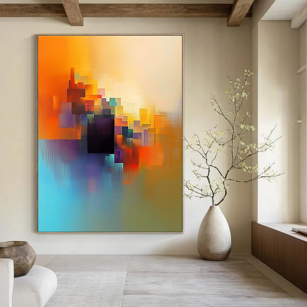 Large abstract painting featuring light orange blue and yellow colors with a serene cityscape and a central dark brown cube.STSC687