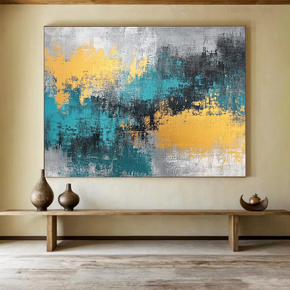Large abstract painting featuring teal, grey, and gold hues that add a vibrant touch to any space.SC260