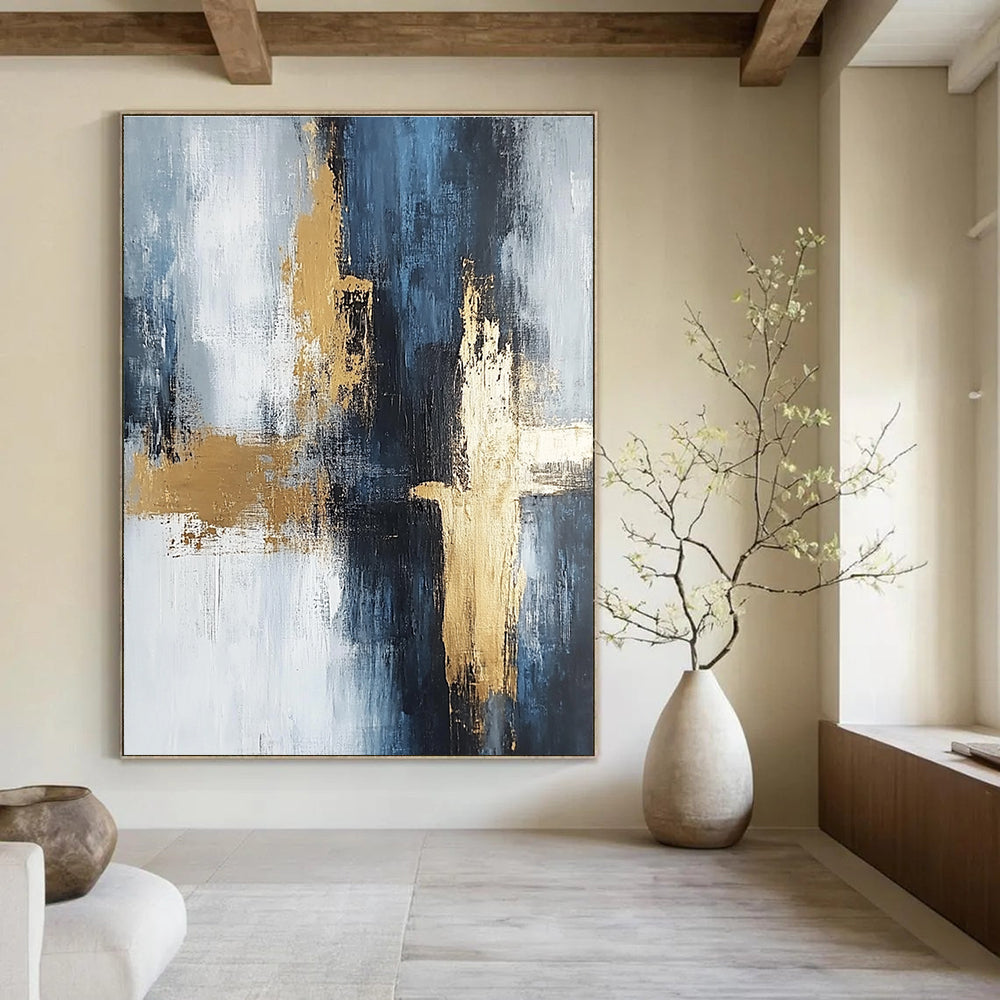 Large abstract painting in light gray and dark blue tones with gold accents featuring strong brushstrokes and delicate textures creating spatial depth.STSC433