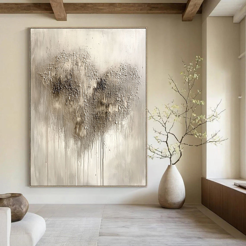 Large abstract painting in silvery gray with impasto texture featuring a heart-shaped pattern and accents of black and dark brown.STSC519