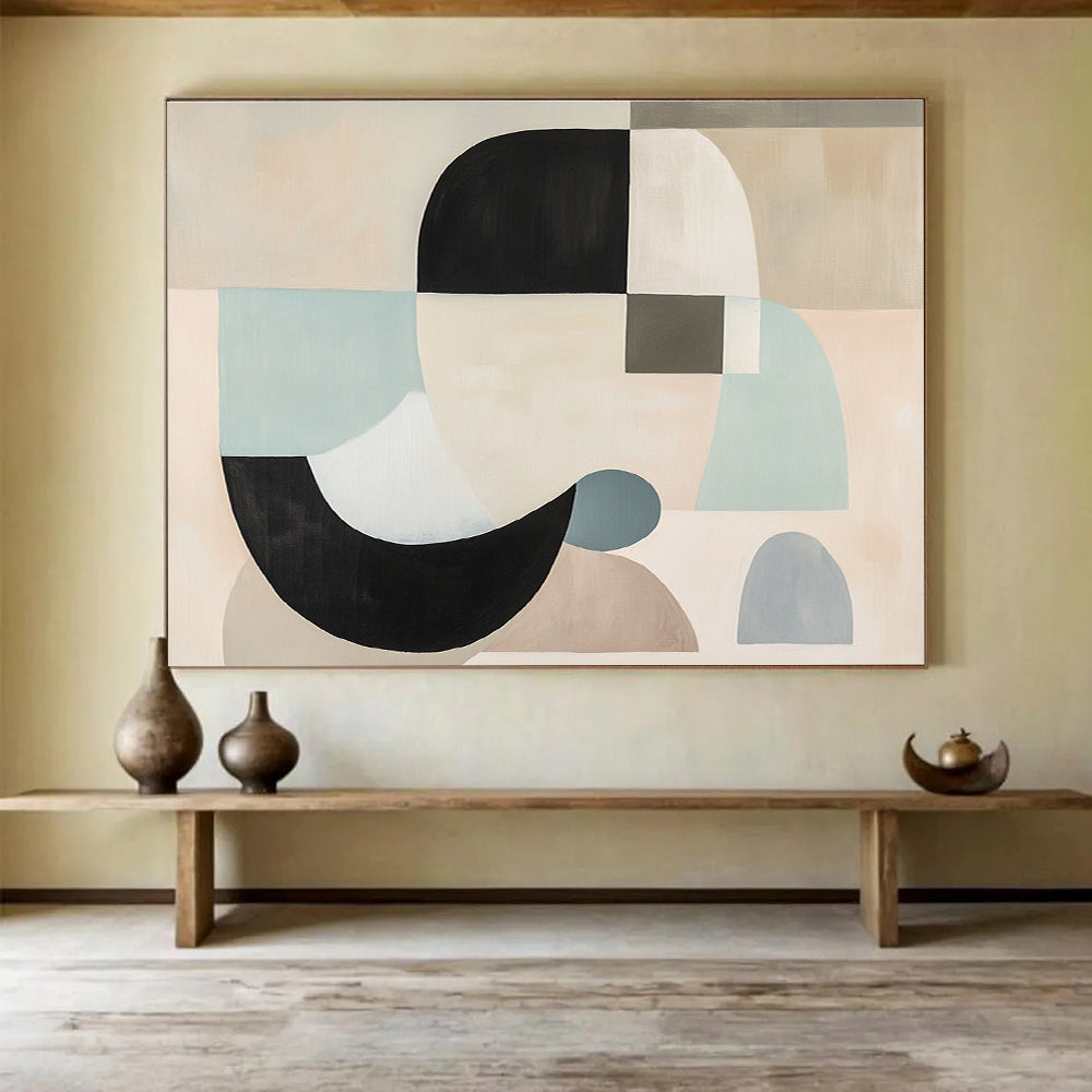 Large abstract painting with white, black, and grey shapes in soft pastel colors featuring geometric forms and a neutral beige background.SC510