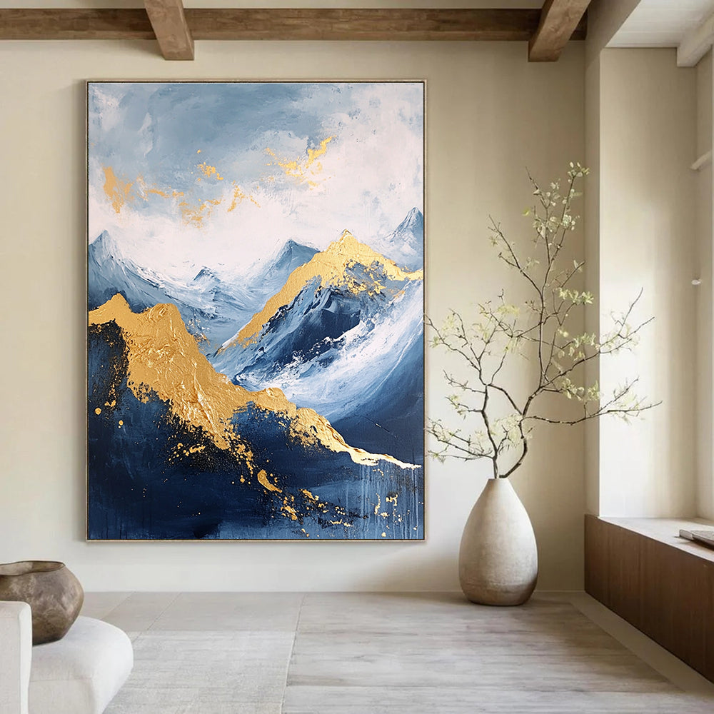 Large abstract painting featuring a golden mountain against a blue sky with white clouds and dark grey stone tones accented with gold.STSC013